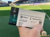 Vstopnica za tekmo Mura : Tottenham. V ozadju je stadion Ljudski vrt v Mariboru.